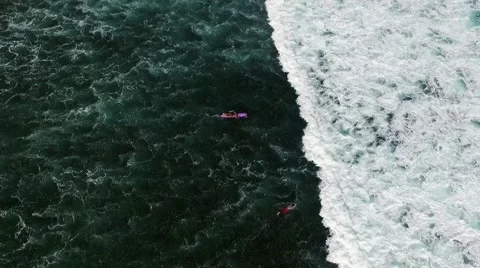 Surfers at the water's edge.Big waves in the Stock Footage 58518692
