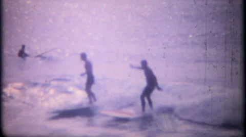 Surfers on waves and girls on beach 1950s vintage film home movie 2556 Stock Footage