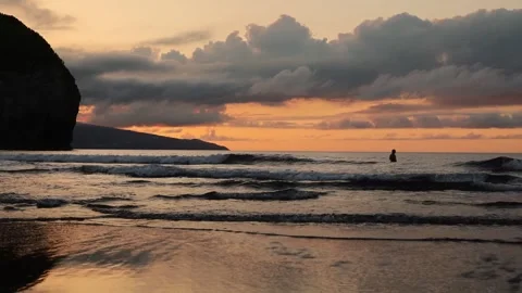 Surfers with waves in Atlantic Ocean, during sunset, video having fun and play. Stock Footage 258565108