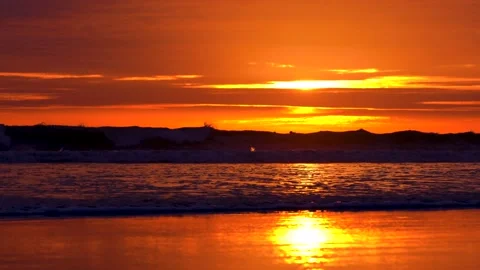 Surfing with beautiful dramatic orange burning sky - 4K footage. Stock Footage 148277851