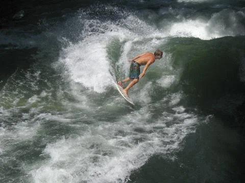 Surfing with a big wave Stock Photos
