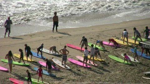 Surfing class practice standing up on boards Stock Footage 457695