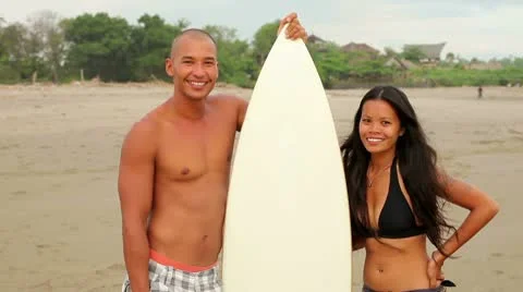 Surfing couple Stock Footage 10802308