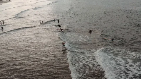 Surfing drone shot during sunset on a beautiful island Stock Footage 103472182