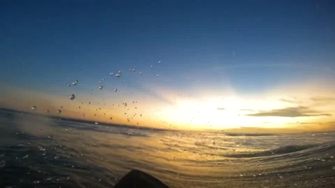 Surfing during sunset in the ocean Stock Footage 197932837