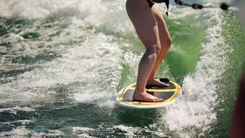 Surfing on a lake with a wakeboard during warm weather in late afternoon Stock-Footage 340076658