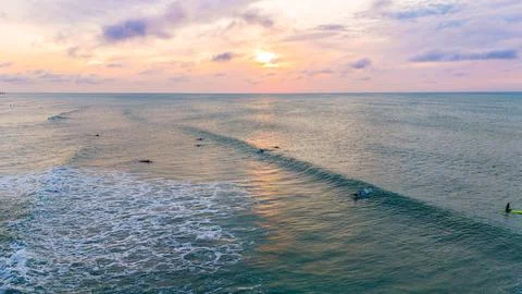 Surfing at sunrise with reflections Stock Photos