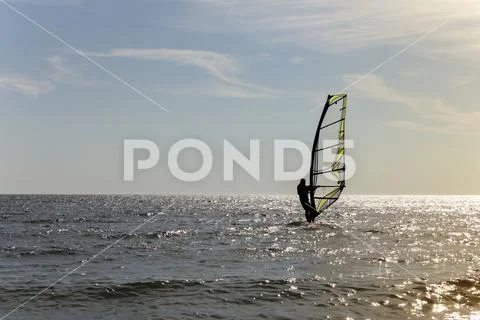 Surfing at Sunset. Outdoor Active Lifestyle. Stock Photos
