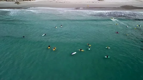Surfing - Surfers Riding Waves In The Beach with Clear Water. - aerial Stock Footage 243595997