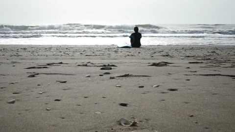 Surfing thinking on the beach shore Stock Footage 234735611