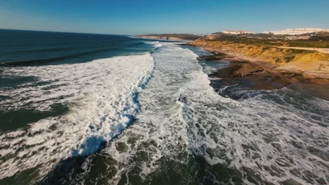 Surfing waves crash against rugged coastline Stock Footage 339786330