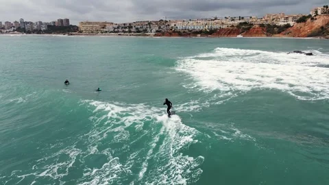 Surfing waves drone view. Seascape and sportsmen practicing surf Видео 270213654