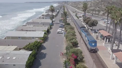 Surfliner Train Leaving San Clemente Station with Ocean and Beach View Stock Footage 93670734