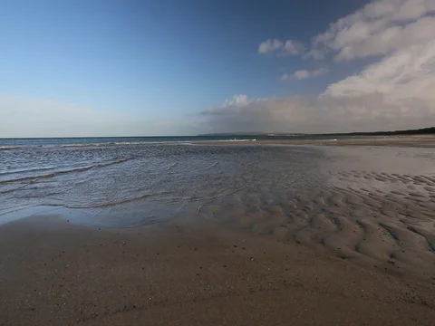 Surge with blue sky at the sandy beach Stock Footage 73120460