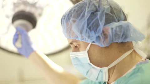 Surgeon Adjusting Lamp in Operating Room Stock Footage 50941762