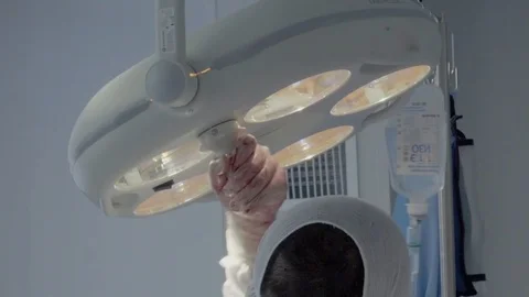 Surgeon adjusts the position of light during the operation. Close-up Video stock 104924277