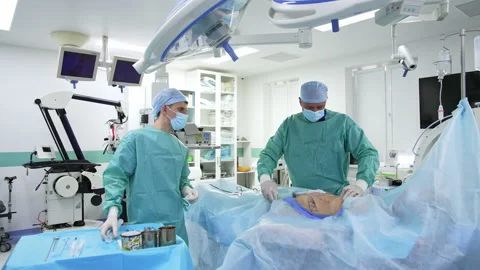 Surgeon and assistant are performing surgery on belly. Liposuction process Stock-Footage 160252962