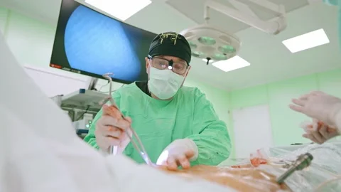 Surgeon and an assistant perform an endoscopic operation Stock Footage 173161104