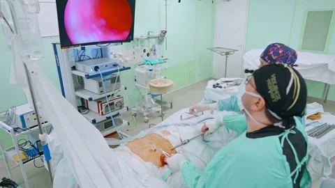 Surgeon and an assistant perform an endoscopic operation Stock Footage 173161468