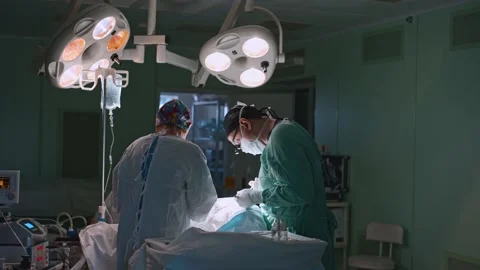 Surgeon and an assistant perform an operation Stock Footage 174128455