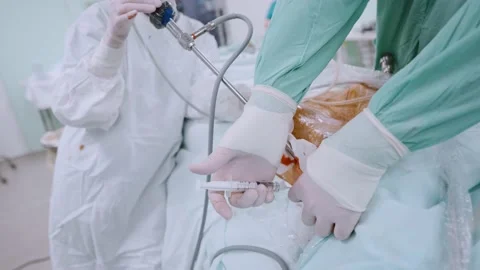 Surgeon and an assistant perform an operation Stock Footage 174129229