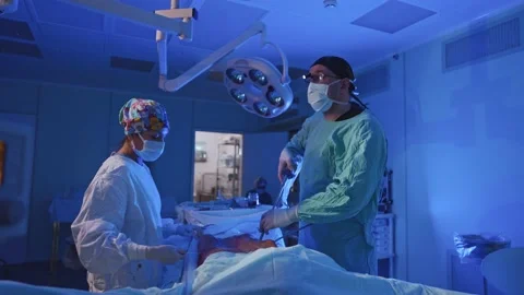 Surgeon and an assistant perform an operation Stock Footage 174129605