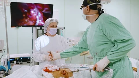 Surgeon and an assistant perform an operation Stock Footage 174130002