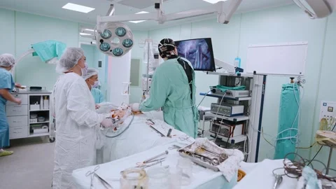 Surgeon and an assistant perform an operation Stock Footage 174130352