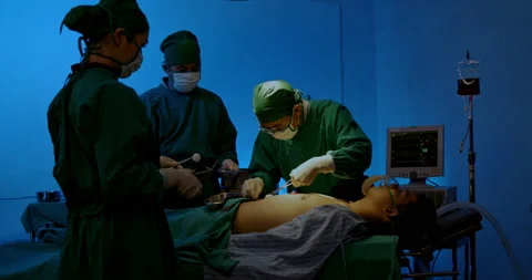 Surgeon and Group doctor assistant are performing abdominal surgery on patients  Stock Footage 198629472