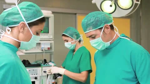 Surgeon and a nurse next to a patient Stock Footage