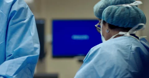 Surgeon and nurses in operating room Stock Footage 67186161