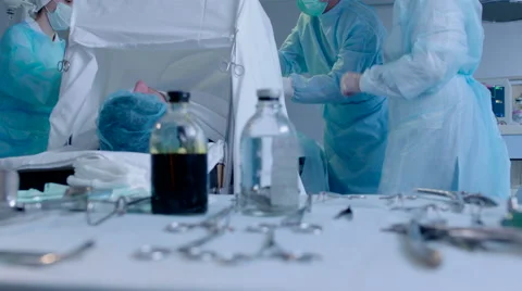 Surgeon and Nurses Performing an Operation Stock Footage 50064085