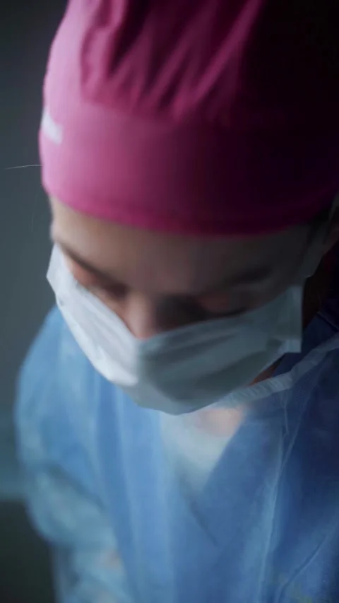 Surgeon carefully performs intricate procedure in sterile environment during Video stock 295864297