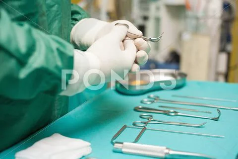 Surgeon choosing a surgical instrument Stock Photos