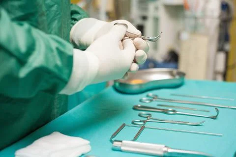 Surgeon choosing a surgical instrument Stock Photos