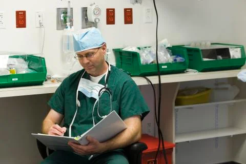 Surgeon completing paperwork Stock Photos