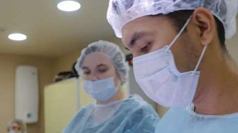 The surgeon is doing the operation. Close-up surgeon face Stock Footage 124414150