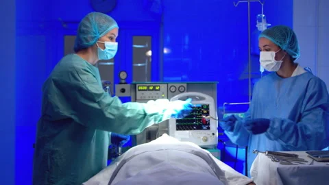 Surgeon doing surgery in operating room in hospital Stock Footage 140754209