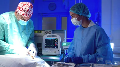 Surgeon doing surgery in operating room in hospital Stock Footage 140756449