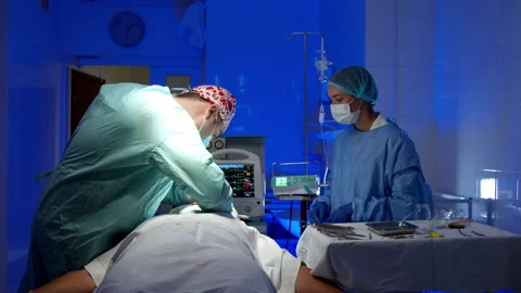 Surgeon doing surgery in operating room in hospital Stock Footage 140757494