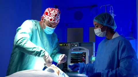 Surgeon doing surgery in operating room in hospital Stock Footage 140758444