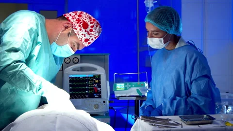 Surgeon doing surgery in operating room in hospital Stock Footage 140764030