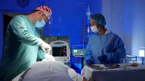 Surgeon doing surgery in operating room in hospital Stock Footage 140764337