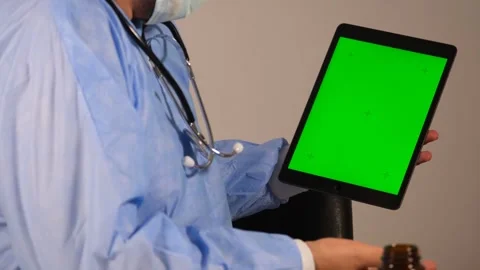 Surgeon explains on green screen Stock Footage 247089032