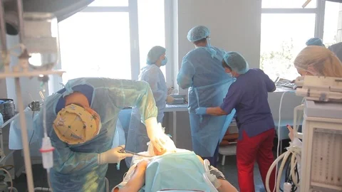 Surgeon getting ready for surgery. puts on a dressing gown, uniform. Video stock 99196645