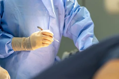 A surgeon holds a scalpel in his hand Stock Photos