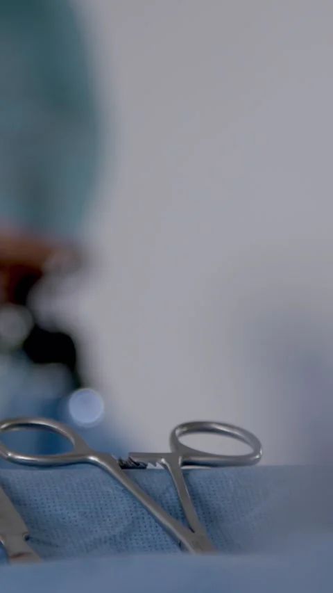 Surgeon With Instruments In Foreground. Vertical Format Stock Footage 328667905