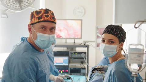 Surgeon looking at camera with colleagues. Team surgeon at work on operating in Stock Footage 174173124