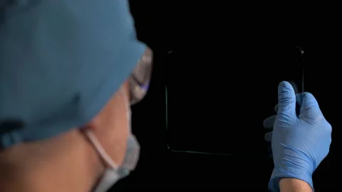 Surgeon Looking Tablet  Stock Footage 146876282