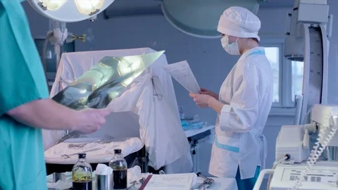 Surgeon looking through the patient's papers Stock Footage 75246924